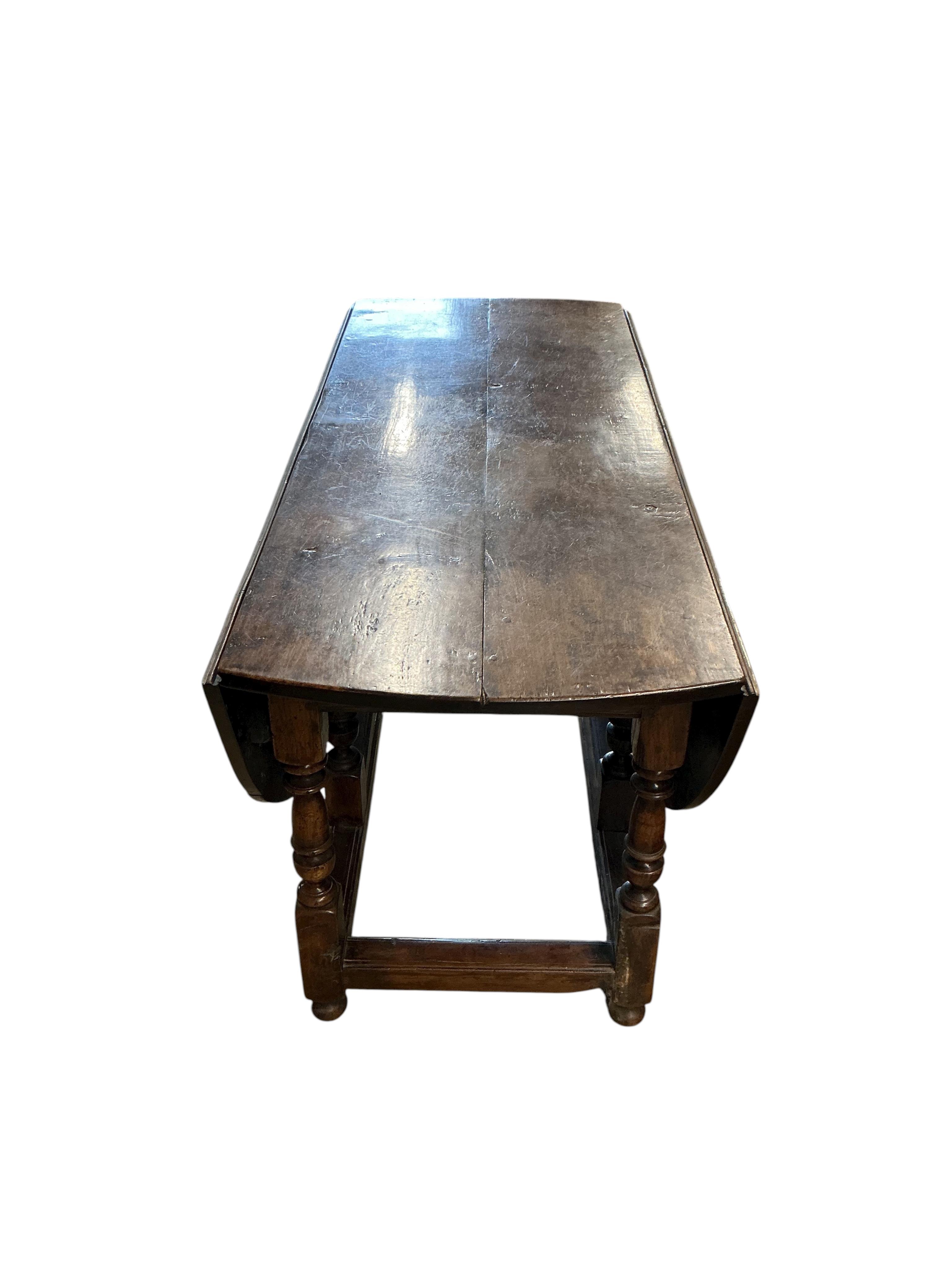 An early 17th century style oak gateleg dining table incorporating earlier elements, width 151cm, depth 62cm, height 75cm